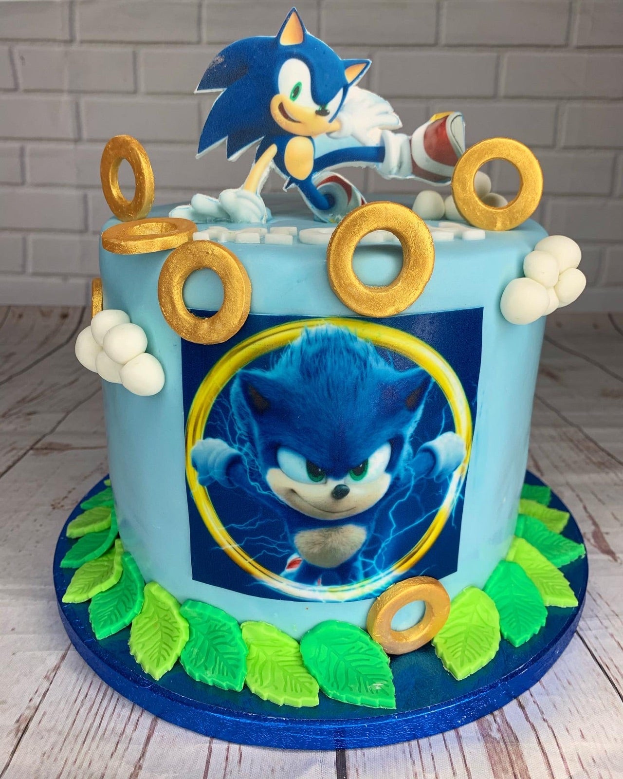 Blue Sonic themed celebration cake with gold ring decorations