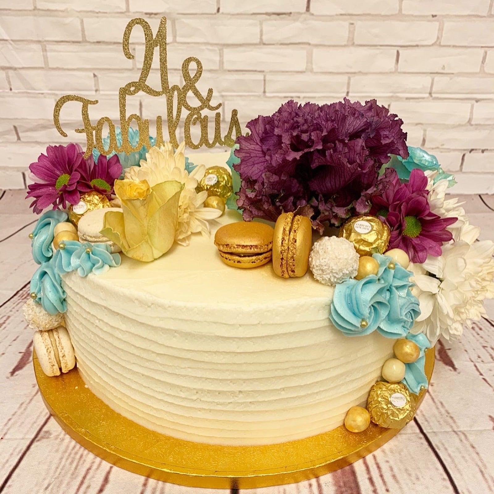 Cream celebration cake with colourful floral decoration