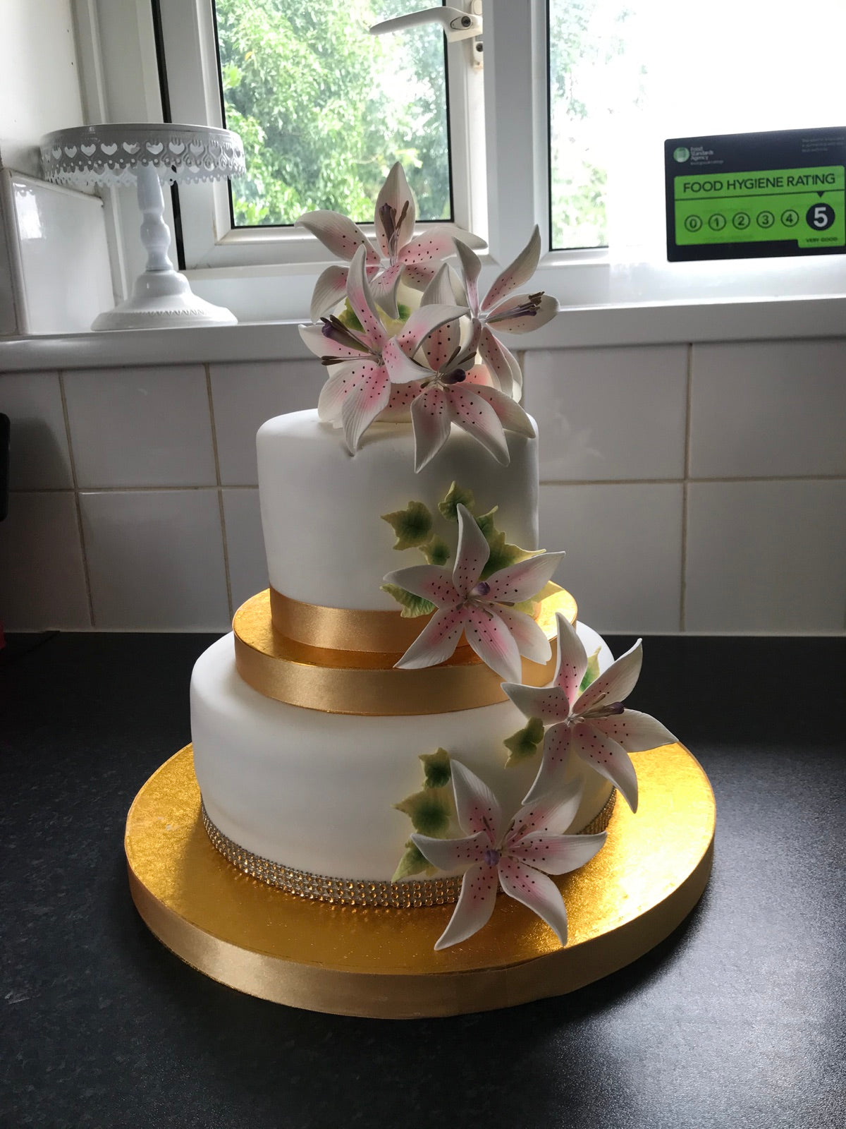 Elegant tiered wedding cake with lily decoration