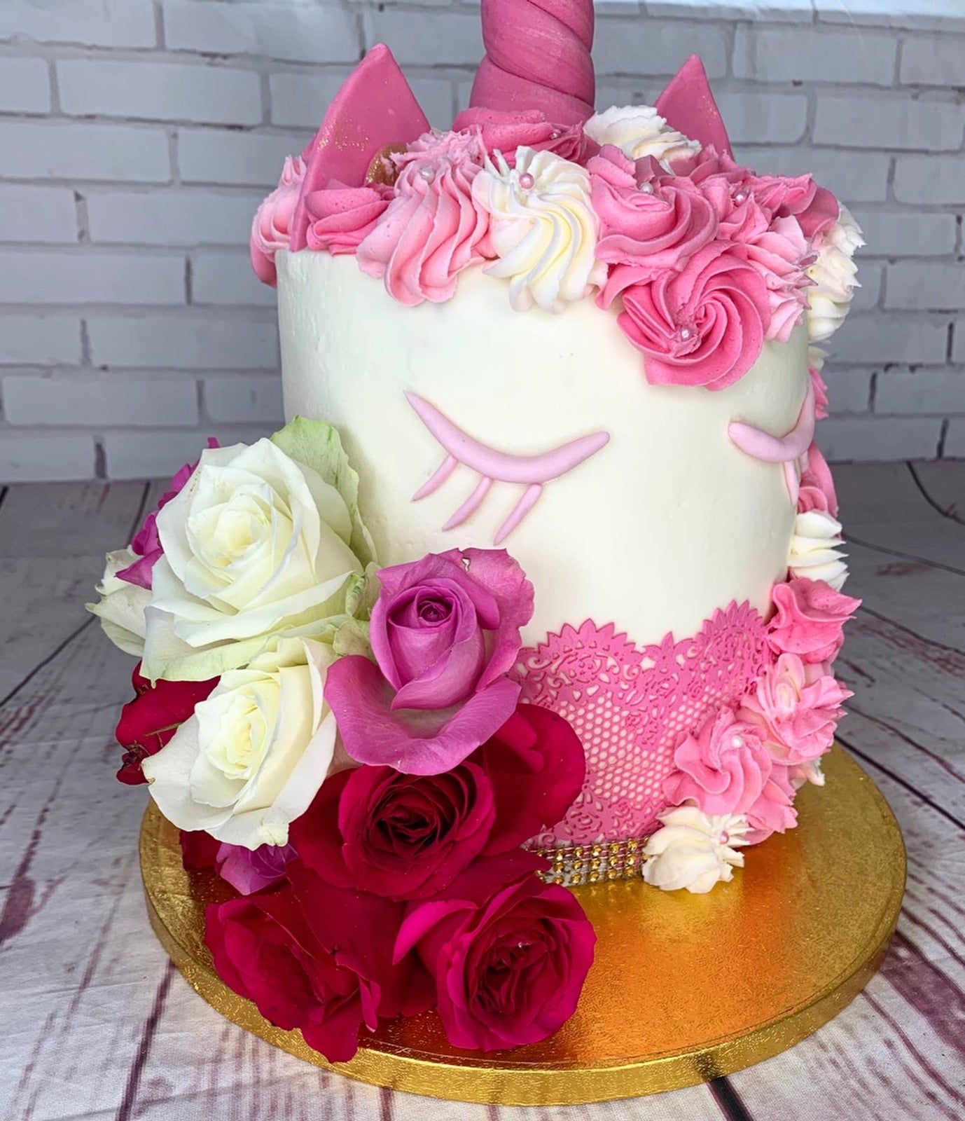 Pink unicorn birthday cake with floral decoration