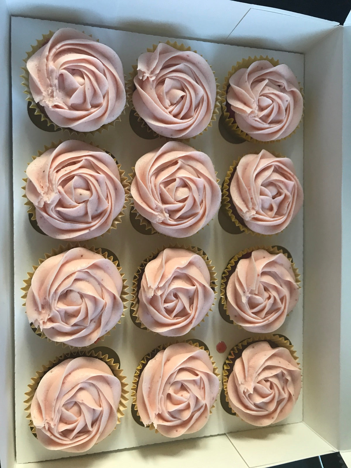 Box of pink frosted cupcakes