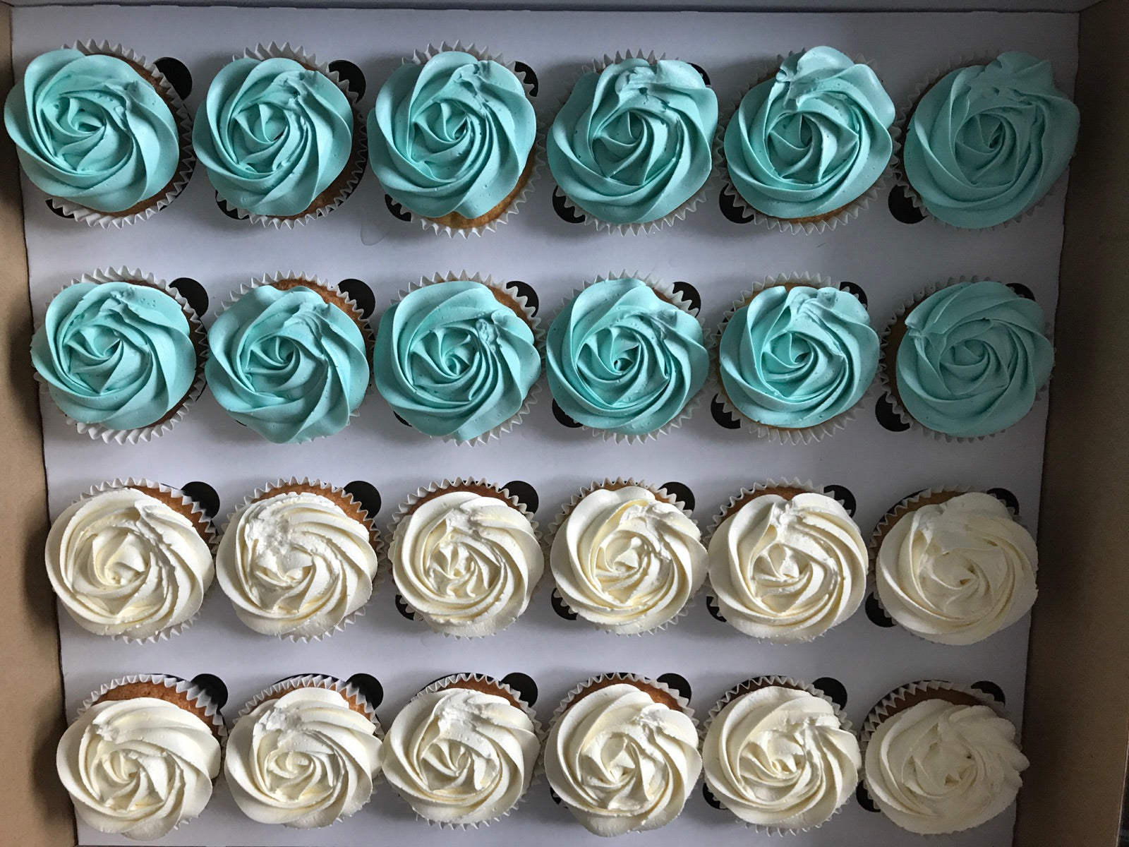 Box of blue frosted cupcakes