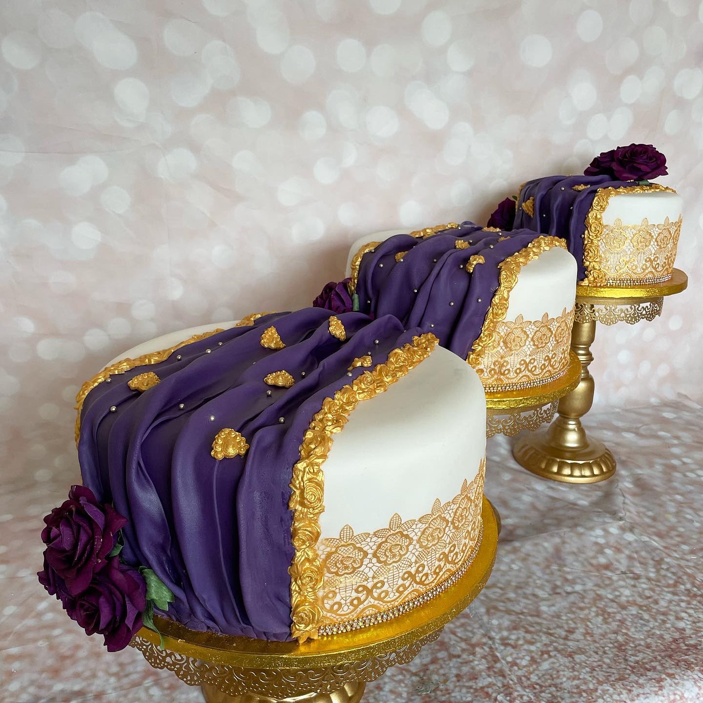 Purple and gold floral wedding cake