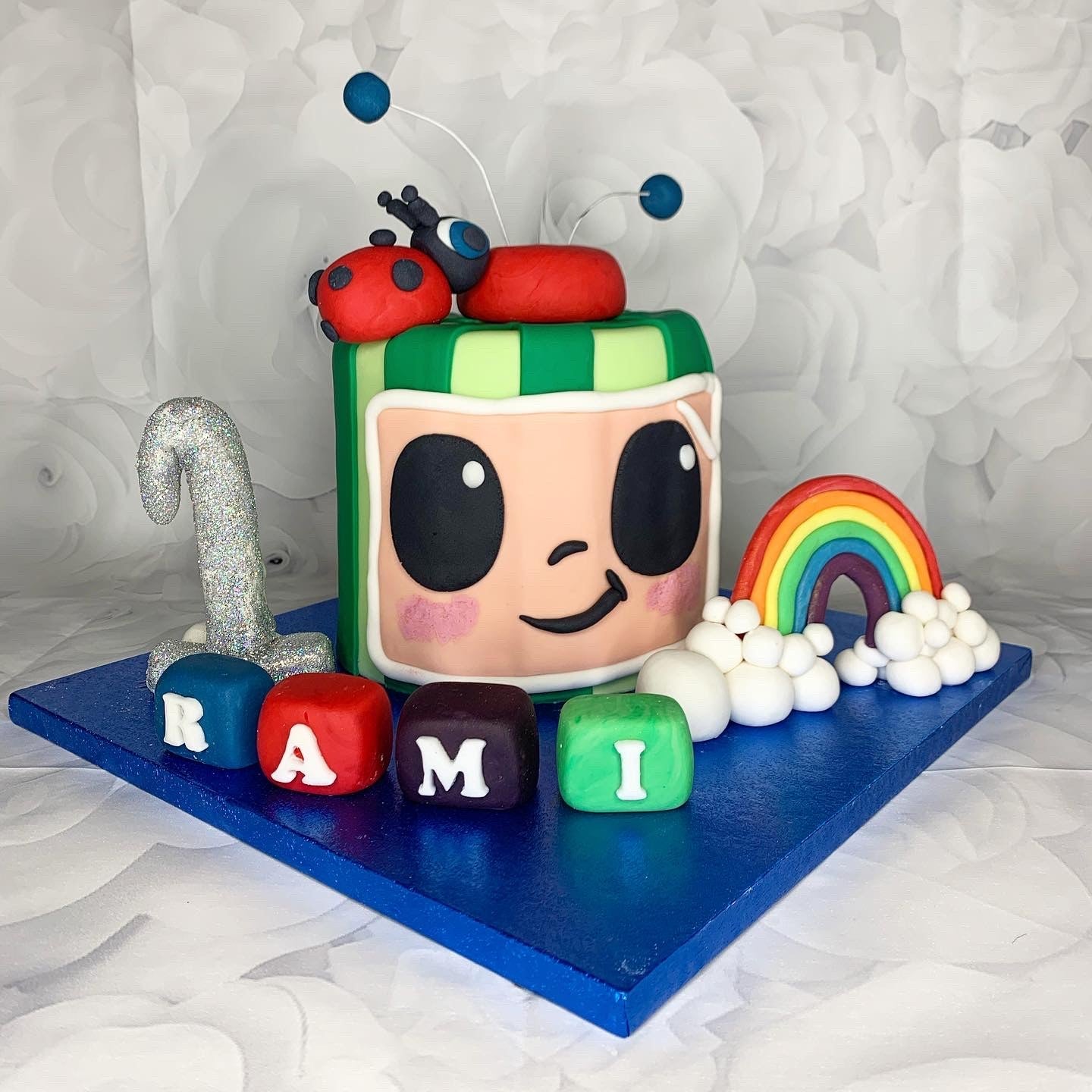 Rainbow television themed celebration cake